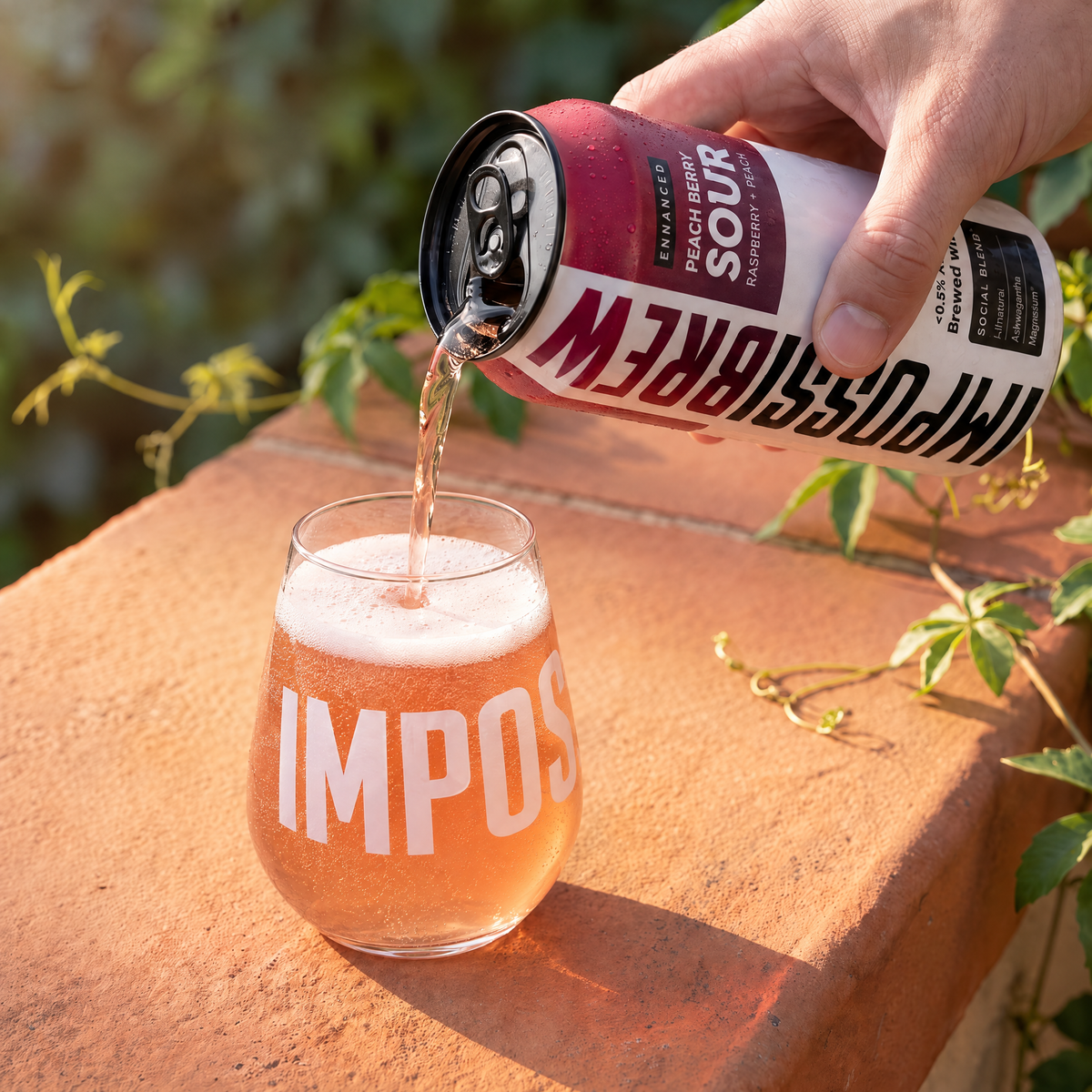 Peach Berry Sour pouring into the Signature Glass on a sunlit terracotta ledge